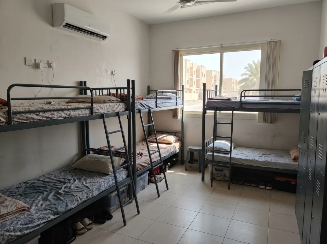 Bulk industrial metal bunk beds assembled inside a worker accommodation facility in Dubai, UAE