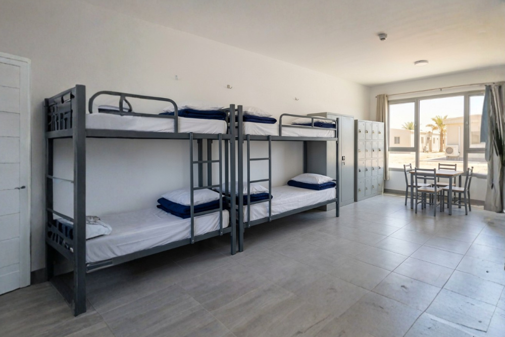 Reliable labour camp furniture suppliers in UAE showcasing steel bunk beds, lockers and wardrobes in a modern worker accommodation room.